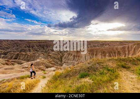 Woman hiking her way through the scenic Badlands, South Dakota, United States of America Stock Photo