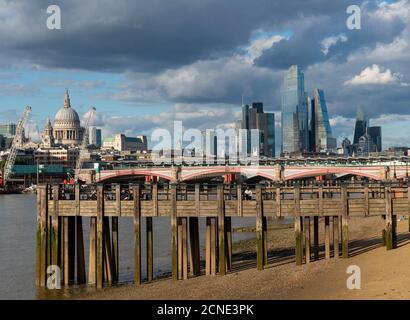 St. Pauls Cathedral and the City of London above old wooden pilings on the Southbank of the River Thames, London, England, United Kingdom, Europe