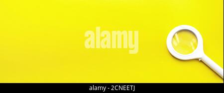 Top view of single magnifying glass with handle on Yellow with soft shadow. Internet search concept Stock Photo