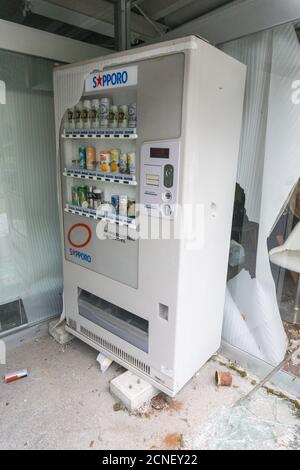 Smashed and broken drinks vending machine in Tenninkyo, Hokkaido, Japan Stock Photo