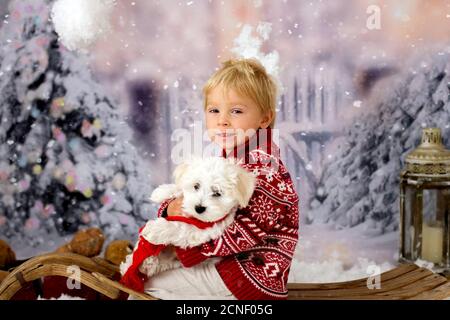 Cute boy, preschool child, playing in the snow outdoors, studio shot Stock Photo