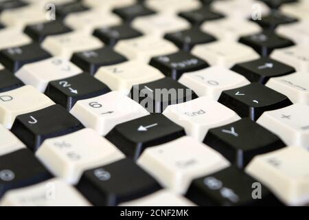 a set of keys from old computer keyboards laid out on the table in a staggered manner Stock Photo