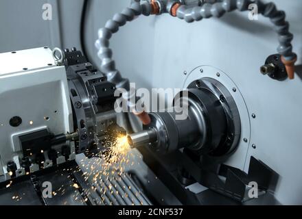 Metal machine tools industry. CNC turning machine high-speed cutting is operation.flying sparks of metalworking Stock Photo