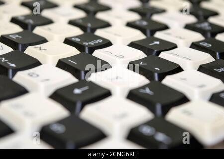 a set of keys from old computer keyboards laid out on the table in a staggered manner Stock Photo