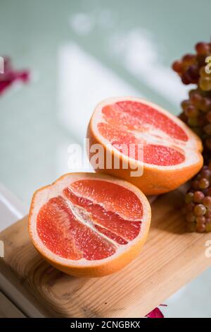 Healthy Organic Red Ruby Grapefruit on wooden background, toned Stock Photo