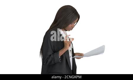 Serious african american woman reading documents while walking o Stock Photo