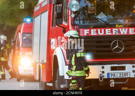 BAVARIA / GERMANY - SEPTEMBER 16, 2020: German firetruck stands on a street near a forest Stock Photo