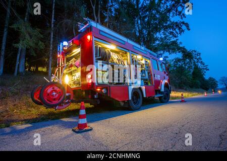 BAVARIA / GERMANY - SEPTEMBER 16, 2020: German firetruck stands on a street near a forest Stock Photo