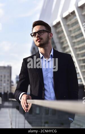 Portrait of confident handsome man, in elegant suit, successful businessman Stock Photo