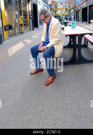 London, England, UK. Man on his mobile phone in Carnaby Street Stock Photo