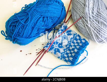 Scandinavian inspired knitted stranded colorwork used in making mittens. Stock Photo