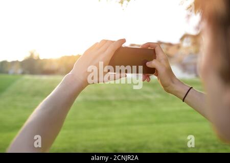 close-up guy takes pictures of nature, beautiful views on his smartphone. free copyspace Stock Photo