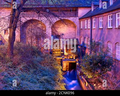 City wall, brick wall, water wheel, tower, passage, hedge, bushes, canal, house, window Stock Photo