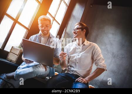 Two business colleagues sitting at a table, having a meeting. Stock Photo