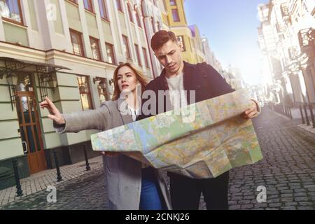 Cute traveling couple walk in city Stock Photo