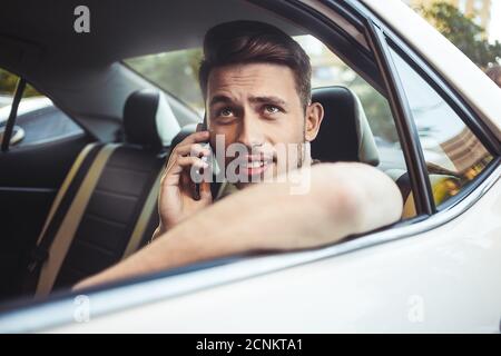 Close up side portrait of happy caucasian man driving car. Stock Photo