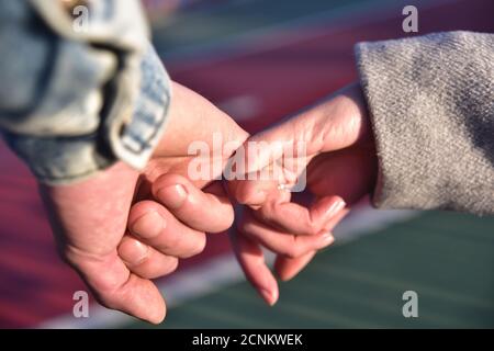Close up photo of couple holding hands. Stock Photo