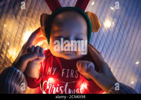 Little baby girl lie on the bed, christmas theme. Stock Photo