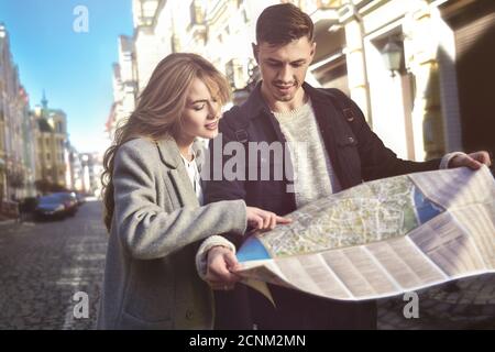Cute traveling couple walk in city Stock Photo