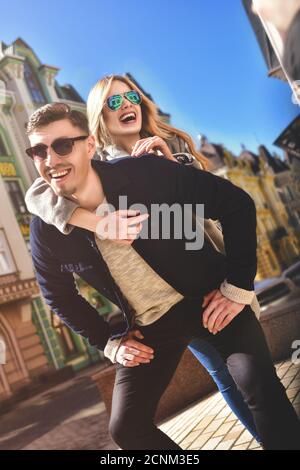 Happy young man piggybacking his girlfriend Stock Photo