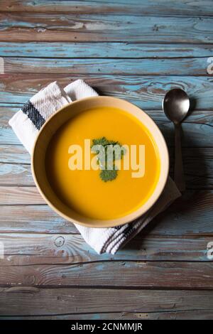 Top view of pumpkin soup in a bowl on a background Stock Photo