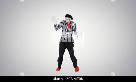 Mime imagining and depicting like he falling from the sky on gra Stock Photo
