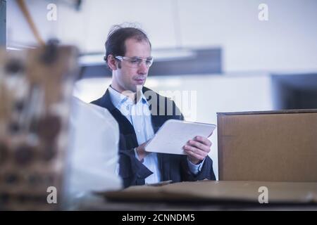 Engineer using a digital tablet in a factory, Germany Stock Photo