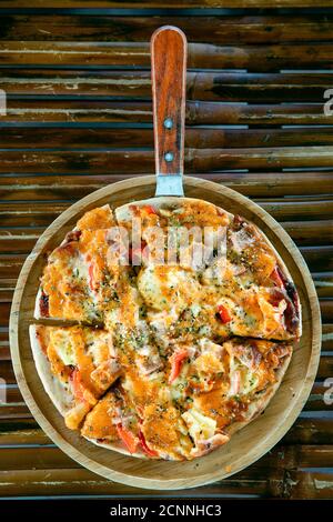 Top view angle homemade pizza on wooden tray natural bamboo background. Stock Photo