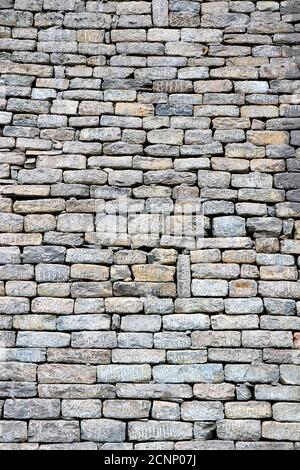 Close-up of stone wall use for construction business and designers. Stone backgrounds textured pattern abstract image. Seamlessly tiling stone wall Stock Photo
