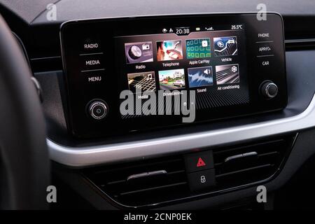 View on a car dashboard with radio, telephone, apple carplay, media, sound, driver assistant, air conditioning icons of Skoda automobile, September Stock Photo