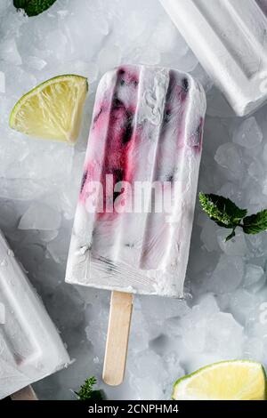 Flat lay of a roasted cherry limeade coconut popsicle. Stock Photo