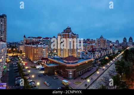 Night aerial view on Obolon area of Kyiv city with illumination. Flying drone camera shot. Stock Photo