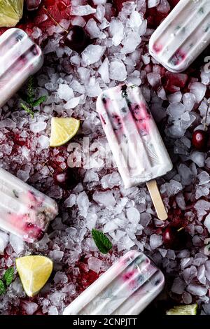 Cherry limeade coconut popsicle flat lay. Stock Photo