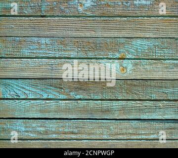Green old painted cracked wooden wall texture as background. Closeup Stock Photo