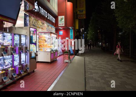 Tokyo, Japan. 17th Sep, 2020. An employee of a Maid Cafe walks past a Gaming Arcade in the famous electronics and Japanese pop culture district Akihabara. Credit: SOPA Images Limited/Alamy Live News Stock Photo