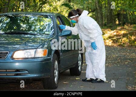 Covid19 Coronavirus healthcare worker performing virus testing outdoors for pandemic Stock Photo