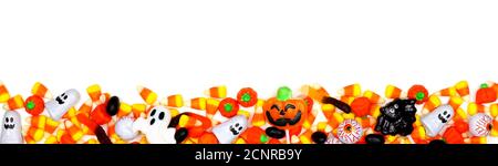 Halloween candy long border. Top view isolated on a white background. Stock Photo