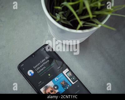 Lod, Israel - July 8, 2020: Modern minimalist office workspace with black mobile smartphone with Discord app play store page on marble background. Top Stock Photo