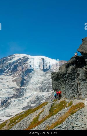 Hikers on the Skyline Trail with Mount Rainier in Mt. Rainier National Park in Washington State, USA. Stock Photo