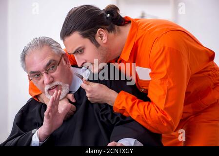 Old judge meeting with young captive in courthouse Stock Photo