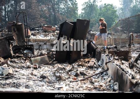 Talent, United States. 18th Sep, 2020. TALENT, ORE - SEPTEMBER 18, 2020: Zach Kuhlow checks the remnants of his house for anything salvagable. His son, who is now 10, was born inside the house. In Talent, about 20 miles north of the California border, homes were charred beyond recognition. Across the western US, at least 87 wildfires are burning, according to the National Interagency Fire Center. They've torched more than 4.7 million acres -- more than six times the area of Rhode Island. Credit: Chris Tuite/imageSPACE Credit: Imagespace/Alamy Live News