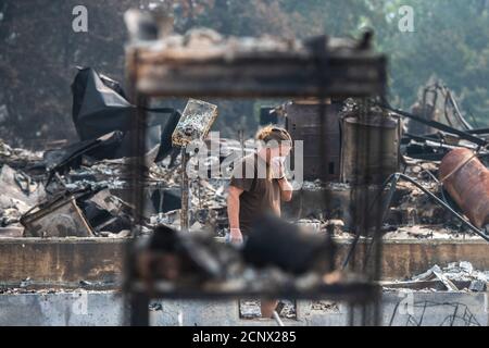 Talent, United States. 18th Sep, 2020. TALENT, ORE - SEPTEMBER 18, 2020: Zach Kuhlow checks the remnants of his house for anything salvagable. His son, who is now 10, was born inside the house. In Talent, about 20 miles north of the California border, homes were charred beyond recognition. Across the western US, at least 87 wildfires are burning, according to the National Interagency Fire Center. They've torched more than 4.7 million acres -- more than six times the area of Rhode Island. Credit: Chris Tuite/imageSPACE Credit: Imagespace/Alamy Live News