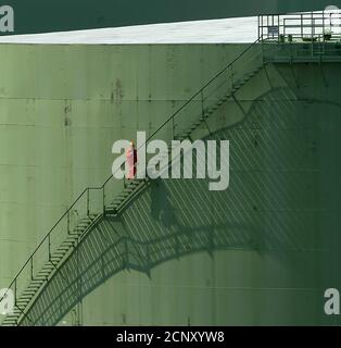 A worker walks up the stairs of an oil storage tank at Germany's Esso fuel and oil storage facility in Ingolstadt.  A worker walks up the stairs of an oil storage tank at Germany's Esso fuel and oil storage facility in Ingolstadt, about 70 kilometers north of Munich, August 9, 2004. U.S. oil prices slipped for the second straight session on Monday, but remained not far off $44 a barrel on lingering worries that there was little spare production capacity in the world to cover any supply hiccup. REUTERS/Alexandra Winkler