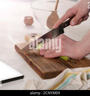 knife cutting, vegetable salad, restaurant kitchen, young caucasian, cutting board, knife cuts, young man, healthy meal Stock Photo
