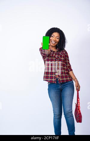 young african lady excitedly showing her phone screen Stock Photo