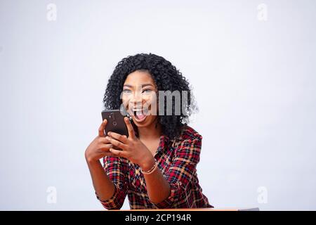 happy young african lady using her phone Stock Photo