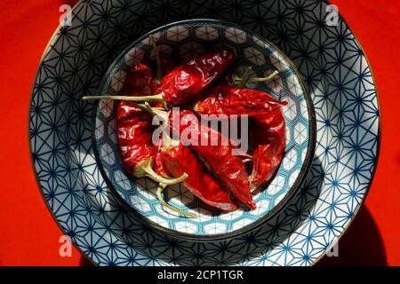 Mortara 09/15/2020: dried red chili peppers in a Japanese style bowl and red dish Stock Photo