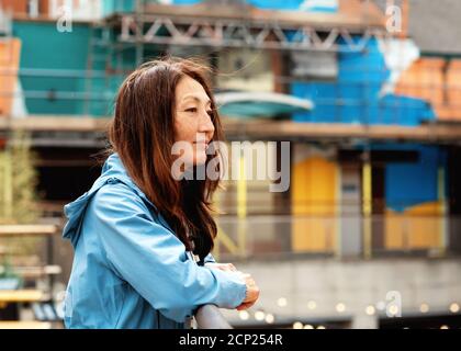 Asian woman in a blue coat walking around Europe city Stock Photo