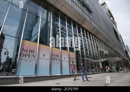 Manhattan, New York, USA. 18th Sep, 2020. Pedestrians wearing PPE masks walk past The Now Open sings for Hudson Yards in Manhattan, New York. Mandatory credit: Kostas Lymperopoulos/CSM/Alamy Live News