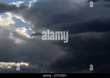 Moisture-filled cumulus clouds float in the sky over the American Southwest. Stock Photo